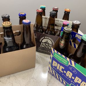 Three 6-packs with a variety of root beers