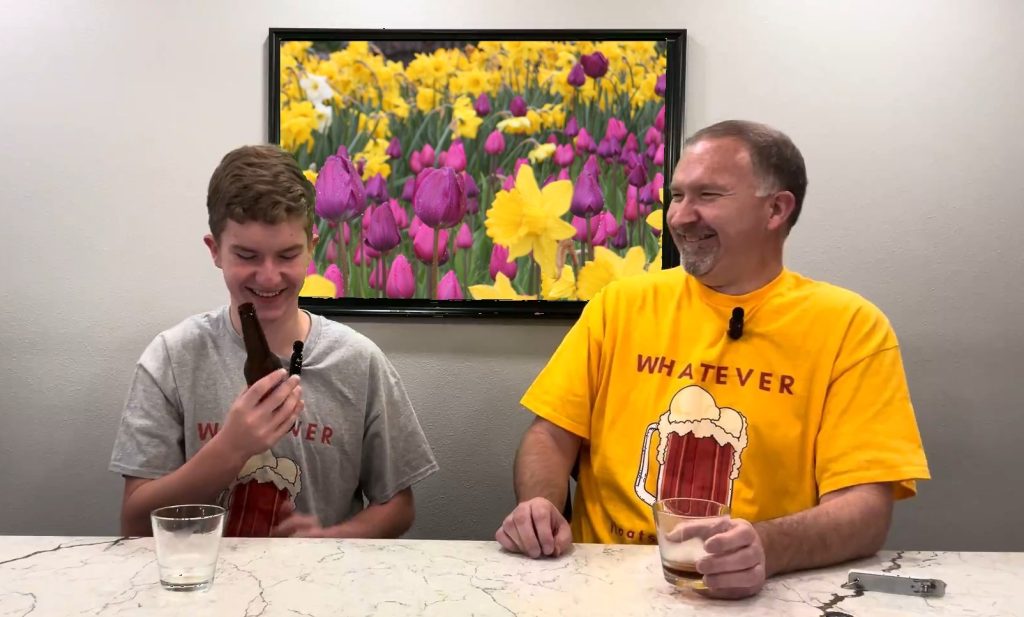 Father and Son laughing while sharing a root beer